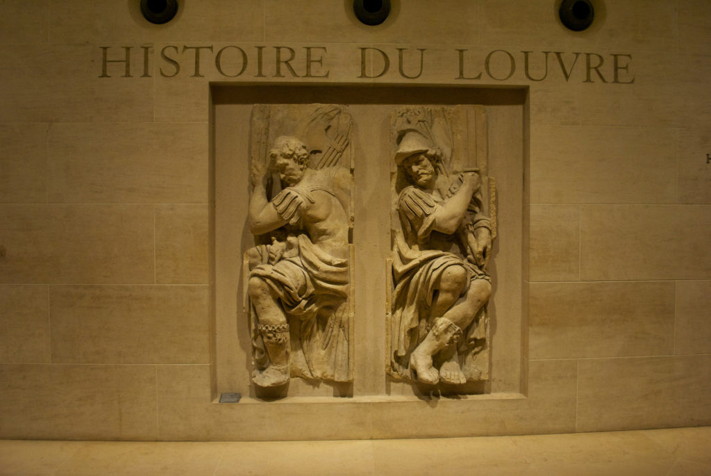 Wall sculpture inside Louvre which reads: Histoire Du Louvre