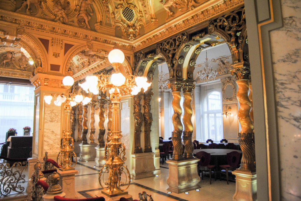 Marble twisting columns, fresco ceiling, and bright lamps